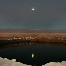 One of the Ojos de Salar (eyes of the salt lake) with full moon